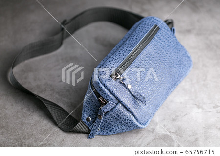 Waist bag made of blue leather, banana on a gray 65756715