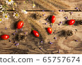 Festive bright autumn background with ripe red dog-rose and dry grass 65757674