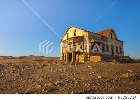 Sunrise above an abandoned house in Kolmanskop ghost town, Namibia Sunrise above an abandoned house in Kolmanskop ghost town, Namibia 65758214