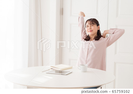 Young woman doing stretching exercises Young woman doing stretching exercises 65759102