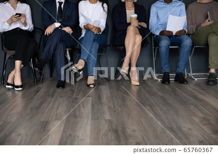 Diverse people sitting in row, candidates waiting for job interview 65760367