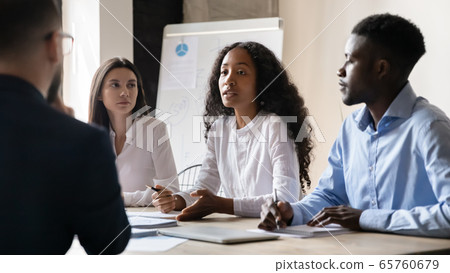 Confident African American businesswoman speaking at corporate meeting in boardroom Confident African American businesswoman speaking at corporate meeting in boardroom 65760679