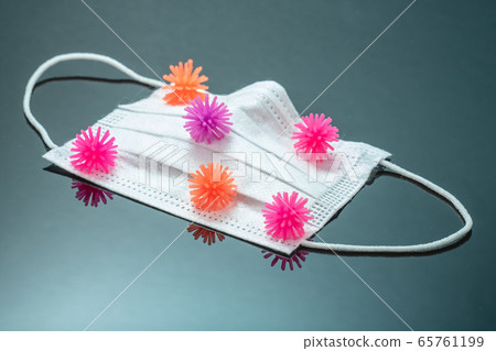 Disposable Dustproof Breathable Surgical Face Mouth Mask with multicolored coronovirus models on black mirror background 65761199