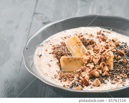 Overnight oats in bowl and ingredients on gray wooden table 65761516