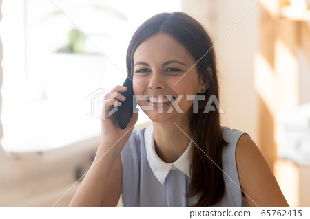 Smiling young girl have pleasant cellphone call Smiling young girl have pleasant cellphone call 65762415