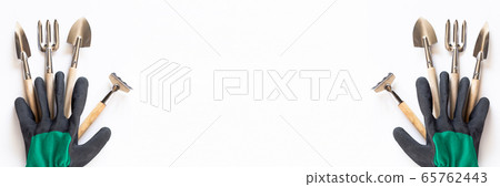 A banner with the farm tools and gloves. Copyspace for text, top view. Categorically on a white A banner with the farm tools and gloves. Copyspace for text, top view. Categorically on a white 65762443