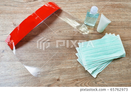 plastic face shield used couple hygienic mask for protection nose and mouth with alcohol or gel based hand sanitized for cleaning disease on table plastic face shield used couple hygienic mask for protection nose and mouth with alcohol or gel based hand sanitized for cleaning disease on table 65762973
