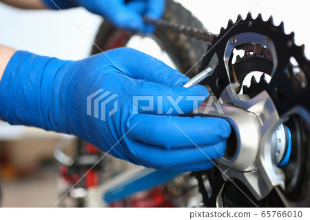 Gloved hands guy repair mechanical part bicycle Gloved hands guy repair mechanical part bicycle 65766010