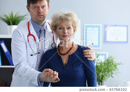 Doctor helps elderly woman to resist during illness Doctor helps elderly woman to resist during illness 65766102