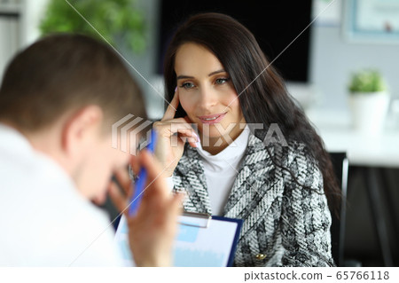 Woman listens attentively to upset office employee 65766118