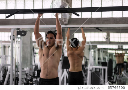 pulling up workout in fitness gym pulling up workout in fitness gym 65766300