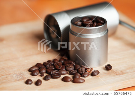 Dark roasted coffee beans are on wooden desk Dark roasted coffee beans are on wooden desk 65766475