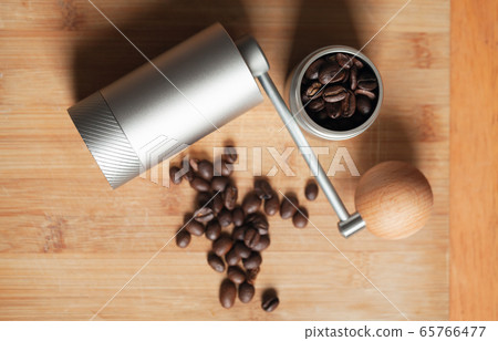 Shiny manual coffee grinder and roasted coffee Shiny manual coffee grinder and roasted coffee 65766477