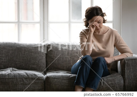 Unhappy mature woman feel anxious lost in thoughts Unhappy mature woman feel anxious lost in thoughts 65766992