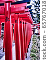 Traditional Japanese red Torii gates at the entrance of an Inari Shinto shrine in Hokkaido. 65767018
