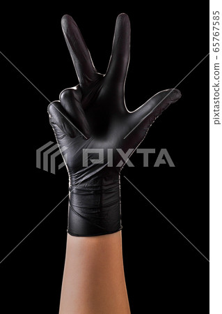 Hand in black gloves showing 3 fingers and Hand in black gloves showing 3 fingers and 65767585