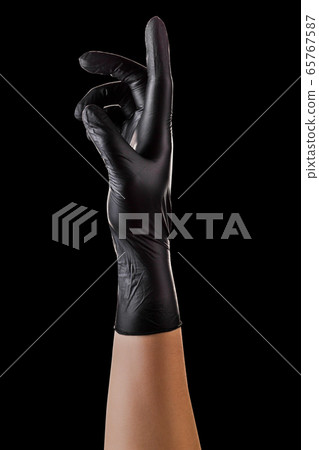 Hand in black gloves with the index finger Hand in black gloves with the index finger 65767587