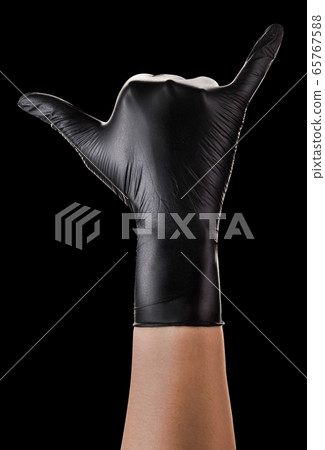 Hand in black gloves showing Shaka or surfer sign Hand in black gloves showing Shaka or surfer sign 65767588