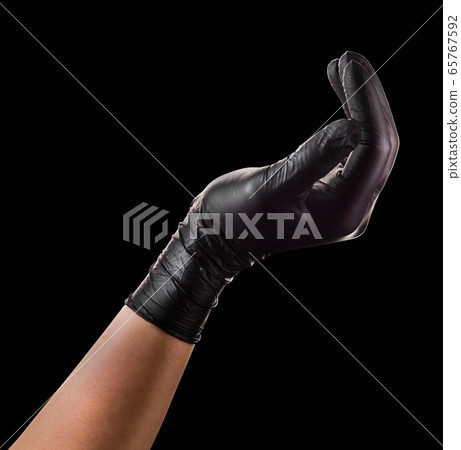 Hand in black glove holding something isolated on Hand in black glove holding something isolated on 65767592