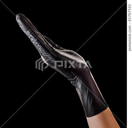 Hand in black glove holding something isolated on Hand in black glove holding something isolated on 65767593