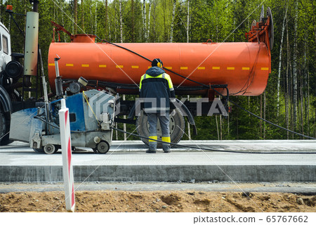 People on road equipment build a concrete road People on road equipment build a concrete road 65767662