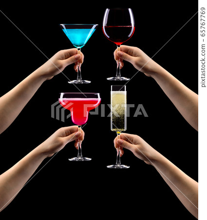 Set of hands holding cocktails isolated on black 65767769
