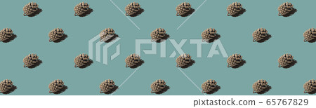 Banneer pattern cone. Isolated object on a blue and green background. Banneer pattern cone. Isolated object on a blue and green background. 65767829