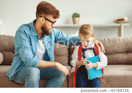 Young father talking to sad schoolkid. 65768726