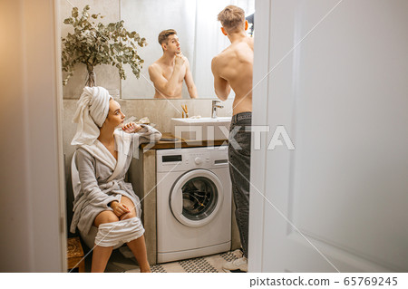 young caucasian couple spend morning together in toilet young caucasian couple spend morning together in toilet 65769245