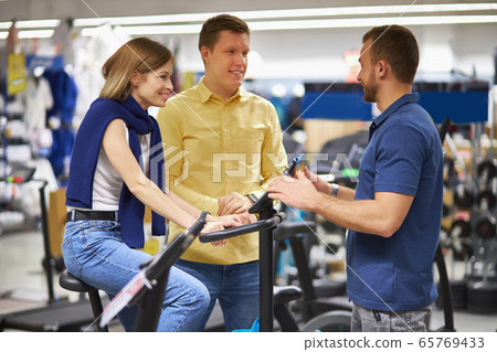 caucasian young customers came in sportswear store 65769433