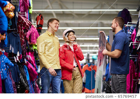 smiling caucasian couple listen to pleasant salesman smiling caucasian couple listen to pleasant salesman 65769457