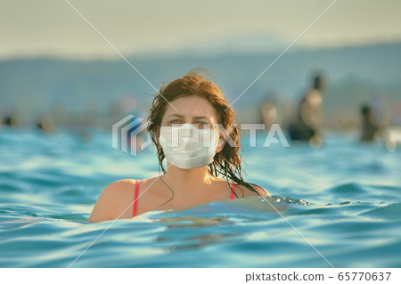 Relaxing during sea season in facial mask. 65770637