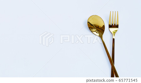 Golden spoon and fork on white background. 65771545