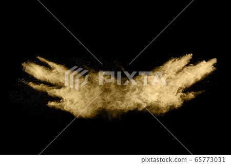 Golden powder explosion on black background. Freeze motion. 65773031