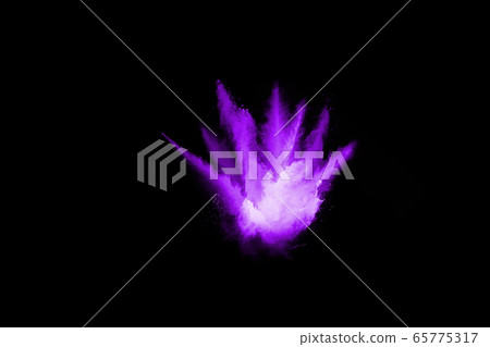 The movement of abstract dust explosion frozen purple on black background. Stop the movement of powdered purple on black background. Explosive powder purple on black background. 65775317