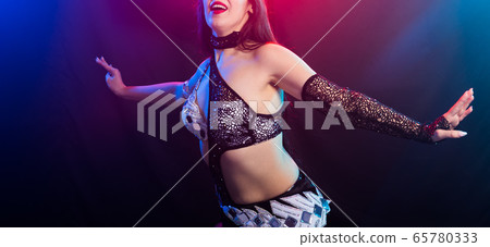 Spirituality dance close-up. Beautiful sexy woman with luxury glossy eastern make-up dancing tribal fusion. Belly dance. 65780333
