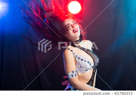 Spirituality dance. Beautiful sexy woman with luxury glossy eastern make-up dancing tribal fusion. Belly dance. Spirituality dance. Beautiful sexy woman with luxury glossy eastern make-up dancing tribal fusion. Belly dance. 65780353