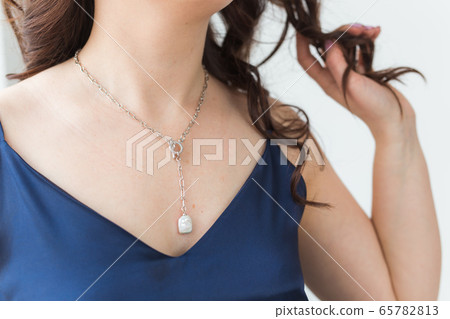 Close-up of woman wearing a Jewelry, bijouterie and accessories. Close-up of woman wearing a Jewelry, bijouterie and accessories. 65782813