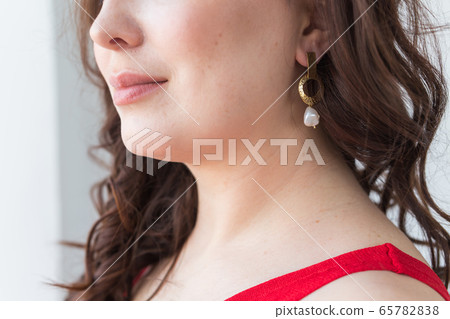 Close-up of woman wearing a Jewelry, bijouterie and accessories. Close-up of woman wearing a Jewelry, bijouterie and accessories. 65782838
