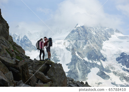 Couple traveling in mountains scenery. Couple traveling in mountains scenery. 65788410