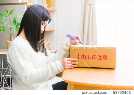 Woman opening cardboard copy space Woman opening cardboard copy space 65790468