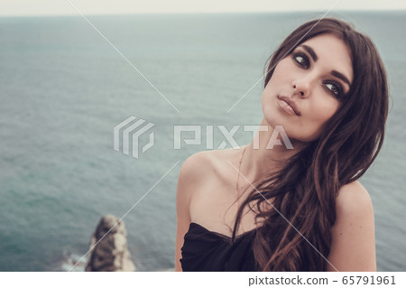 Portrait of beautiful young lady. Outdoors. Smoky Portrait of beautiful young lady. Outdoors. Smoky 65791961