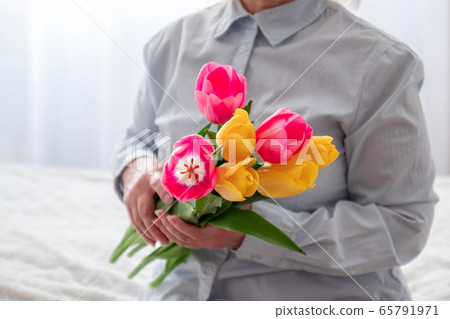 Happy mother's day. Women's hands hold a bouquet Happy mother's day. Women's hands hold a bouquet 65791971