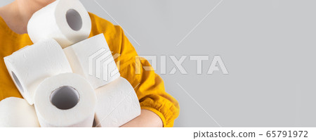 Female hands holds many rolls of toilet paper on 65791972
