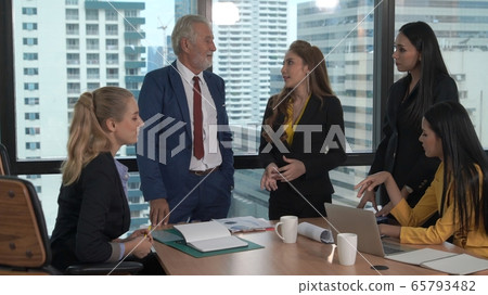 Professional business people discuss financial issue in group meeting at company office. Professional business people discuss financial issue in group meeting at company office. 65793482