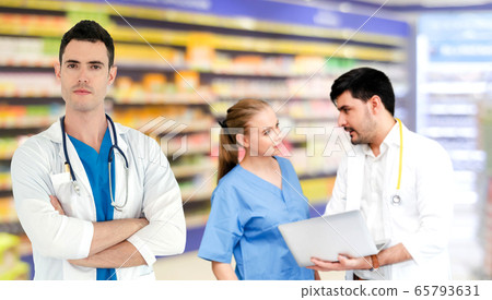 Doctor working in hospital with other doctors. 65793631