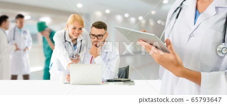Doctor working in hospital with other doctors. Doctor working in hospital with other doctors. 65793647
