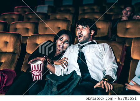 Audience sit in a cinema and watch horror movie Audience sit in a cinema and watch horror movie 65793651