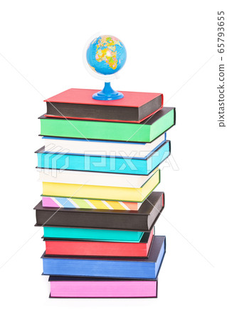 A globe on top of stack of colorful books 65793655