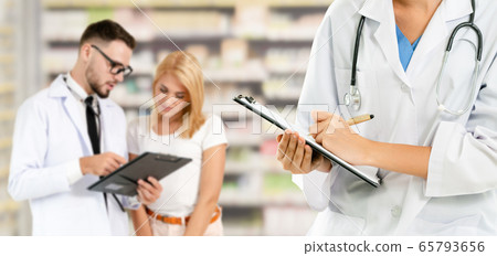 Doctor working in hospital with other doctors. 65793656